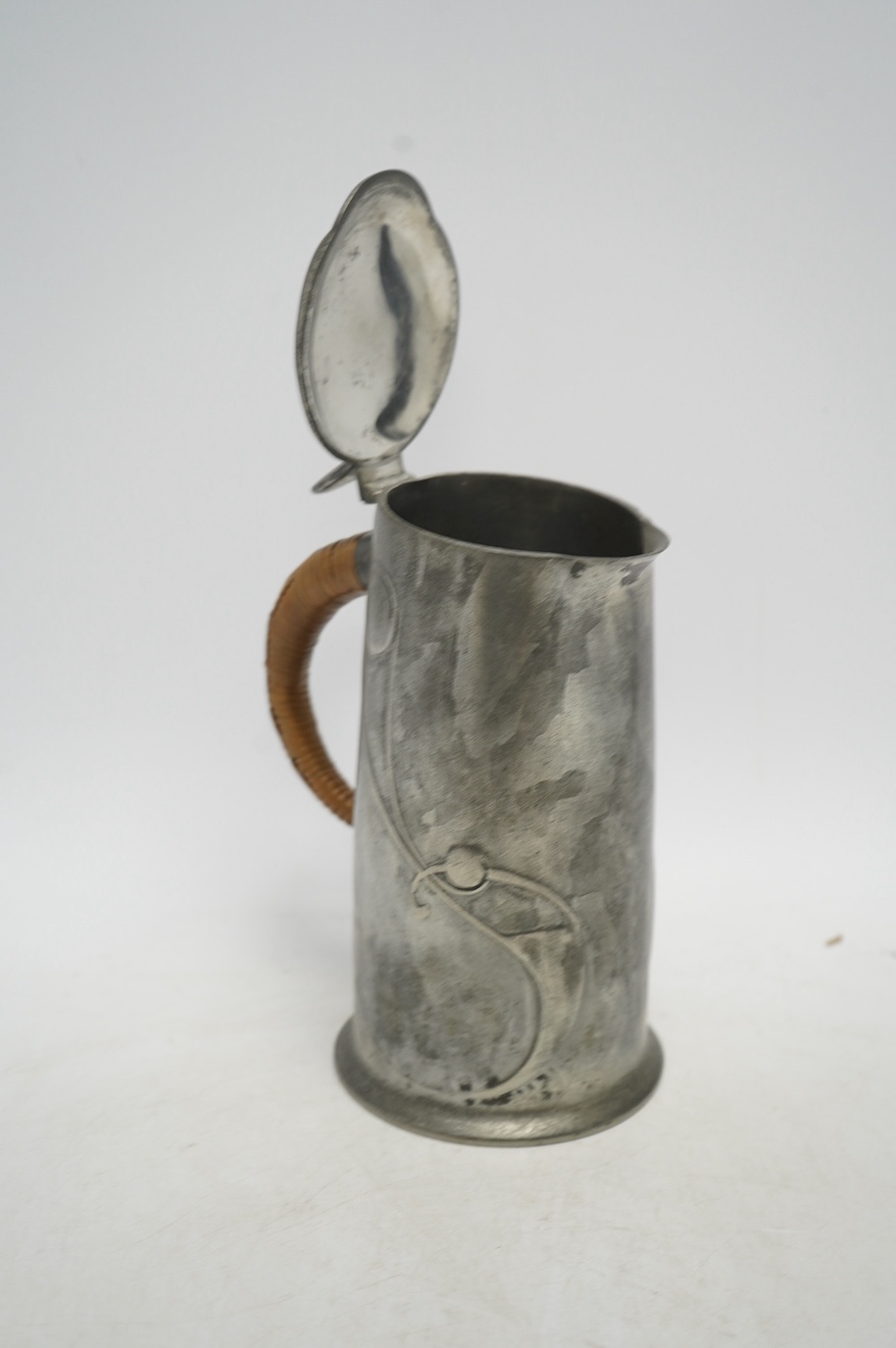 Archibald Knox, an Arts & Crafts Tudric pewter jug, with wicker handle, numbered 0305, 21cm high. Condition - good